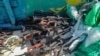 FILE - This Feb. 12, 2021 photo released by the U.S. Navy shows a large cache of weapons, including Kalashnikov-style rifles and rocket-propelled grenade launchers, it seized from a smuggler's ship off the coast of Somalia. 