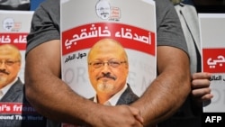 FILE - Friends of slain Saudi journalist Jamal Khashoggi hold posters bearing his picture as they attend an event marking the second anniversary of his assassination in front of Saudi Arabia's Istanbul consulate, Oct. 2, 2020. 