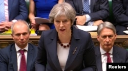 PM Inggris Theresa May memberikan pidato di hadapan parlemen Inggris, Rabu (14/3).