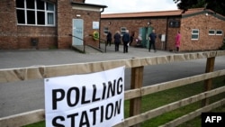 Voters arrive to a polling station at the Scout & Guide headquarters in Sowerby, north of England, July 4, 2024 as Britain holds a general election. Polls are predicting that Labour will win its first general election since 2005.