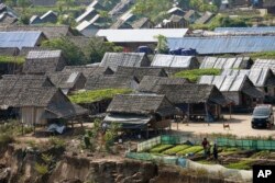 A camp for internally displaced people in Myanmar as seen across the Moei river from Mae Sot in western Thailand, Feb. 8, 2024.