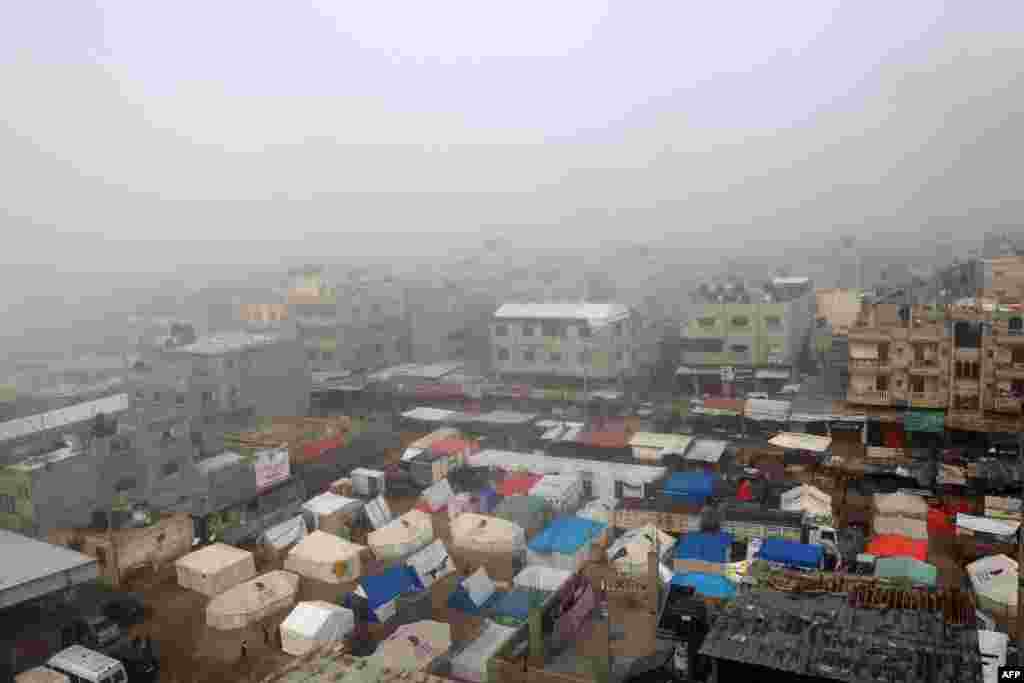 Fog covers buildings and tents set up by displaced Palestinians in Rafah in the southern Gaza Strip, Feb. 25, 2024, amid continuing battles between Israel and the Palestinian militant group Hamas. 