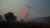 A plane uses retardant to put out a fire in Safed, Israel, June 12, 2024. Scores of rockets were fired from Lebanon toward northern Israel June 12, and Hezbollah said it had launched rockets and weaponized drones at nine Israeli military sites June 13.