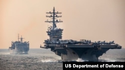 The aircraft carrier USS Dwight D. Eisenhower in the Strait of Hormuz, between the Persian Gulf and the Gulf of Oman, Dec. 14, 2023.