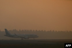 A Kuwait Airways aircraft prepares to take off during heavy air pollution at Indira Gandhi International Airport in New Delhi, India, Oct. 27, 2023.