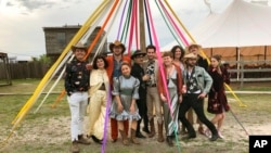 Wedding guests who adhered to the dress code of "Space Disco Cowboy," pose at a wedding in Austin, Texas on March 30, 2019. More than ever, wedding guests are contending with nontraditional dress code requests. (Rikki Gotthelf via AP)