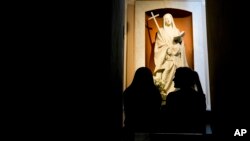 Florencia Pittaluga, right, and Maria Eugencia Iturriza visit the tomb of María Antonia de Paz y Figueroa, more commonly known by her Quechua name of 'Mama Antula,' at the Nuestra Senora de la Piedad Basilica, in Buenos Aires, Argentina, Jan. 30, 2024. 