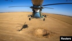 A Ukrainian military Mi-8 helicopter flies in the sky in an undisclosed location in Eastern Ukraine, Sept. 29, 2023, in a screen grab taken from video.