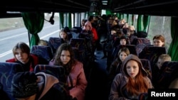 Children who went to a Russian-organized summer camp from non-government controlled territories, and were then taken to Russia, wait for departure to Kyiv after returning via the Ukraine-Belarus border in Ukraine's Volyn region on April 7, 2023. (Valentyn Ogirenko/Reuters)
