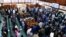 Ugandan lawmakers stand as they pass the Anti-Homosexuality Bill at a session inside the Parliament buildings in Kampala, Uganda, May 2, 2023. 