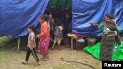 FILE - People displaced by fighting in north-western Myanmar between junta forces and anti-junta fighters are seen at a camp in Chin State, Myanmar, May 31, 2021.