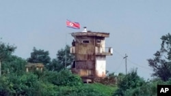 FILE - A North Korean soldier stands at the North's military guard post as a North Korean flag flutters in the wind, in this view from Paju, South Korea, July 24, 2024.