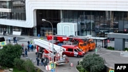 Emergency personnel work outside a damaged office block of the Moscow International Business Center (Moskva City) following a reported drone attack in Moscow on Aug. 1, 2023. 