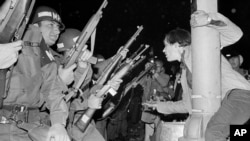 FILE - Chicago police officers attempt to disperse demonstrators outside the Conrad Hilton, Democratic Convention headquarters hotel, Aug. 29, 1968. 