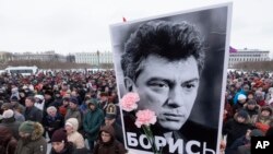 FILE - People gather in memory of opposition leader Boris Nemtsov in St. Petersburg, Russia, on Feb. 26, 2017. Once deputy prime minister, Nemtsov was a popular politician and harsh critic of Vladimir Putin. He was gunned down by assailants on a bridge near the Kremlin in 2015.