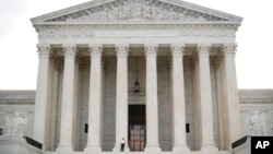 FILE - Police office guards the main entrance to the Supreme Court in Washington, Oct. 9, 2018.