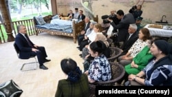 Uzbekistan's new constitution opens the door for President Mirziyoyev, seated at left, to remain in power for the next 14 years.