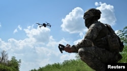 A Ukrainian serviceman of 108th separate territorial defense brigade launches a drone near a front line, amid Russia's attack on Ukraine, in Zaporizhzhia region, Ukraine, August 4, 2023. 