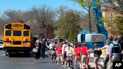 FILE - Students are taken to a reunification site after a deadly shooting at their school in Nashville, Tennessee, March 27, 2023. The United States is setting a record pace for mass killings in 2023, with an average of one every 6.53 days, according to a data analysis.