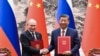 In this photo released by Xinhua News Agency, Chinese President Xi Jinping, right, and Russian President Vladimir Putin attend a signing ceremony at the Great Hall of the People in Beijing, May 16, 2024.