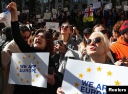 People take part in a rally outside a parliament building during a plenary session of parliament on the controversial "foreign agents" bill, that sparked mass protests in recent days, in Tbilisi, Georgia, March 10, 2023.