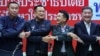 Bhumjaithai Party leader Anutin Charnvirakul (2-L) and Pheu Thai Party leader Chonlanan Srikaew (2-R) shake hands after a press conference about forming an alliance between Pheu Thai and Bhumjaithai party, in Bangkok, Thailand, Aug. 7, 2023.