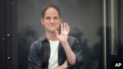 FILE - Wall Street Journal reporter Evan Gershkovich stands in a glass cage in a courtroom at the First Appeals Court of General Jurisdiction in Moscow, Russia, April 23, 2024.