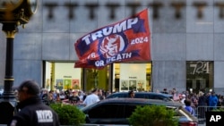 A crowd gathers across the street from Trump Tower, in New York, May 31, 2024.