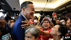 Pheu Thai Party's Srettha Thavisin, center, is hugged by supporters at the party headquarters after the parliament's prime ministerial vote in Bangkok on Aug. 22, 2023. 