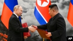 FILE - Russian President Vladimir Putin, left, and North Korea's leader Kim Jong Un exchange documents during a signing ceremony of a new partnership agreement in Pyongyang, North Korea, June 19, 2024.