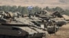 Tank-tank Israel terlihat di dekat perbatasan dengan Israel, di Lebanon, Sabtu 14 Oktober 2023. (Foto: AP/Petros Giannakouris)