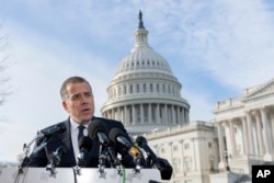 Hunter Biden, son of President Joe Biden, talks to reporters at the U.S. Capitol, in Washington, Dec. 13, 2023.