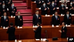 资料照片：习近平（中）出席2023年3月11号在北京召开的中国第十四届人大第一次会议。