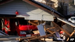 A fire truck sits in a damaged fire house in Wajima on the Noto peninsula northwest of Tokyo, Jan. 5, 2024, after Monday's deadly earthquake.