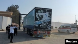 A view of Egyptian trucks carrying humanitarian aid as they drive through the Rafah crossing from the Egyptian side, amid the ongoing conflict between Israel and the Palestinian Islamist group Hamas, in Rafah, Egypt, Nov. 1, 2023.