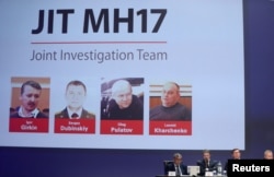 FILE - Four suspects, including Igor Girkin, are shown on screen as investigators present their findings in the downing of Malaysia Airlines flight MH17, nearly five years after the crash, in Nieuwegein, Netherlands, June 19, 2019.