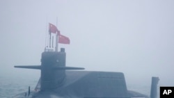 FILE - In this April 23, 2019, photo, a type 094A Jin-class nuclear submarine Long March 10 of the Chinese People's Liberation Army (PLA) Navy participates in a naval parade near Qingdao in eastern China's Shandong province. 