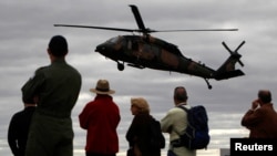 FILE - Spectators watch as a Sikorsky UH-60 Black Hawk helicopter belonging to the Australian Army conducts an exercise during the Australian International Airshow in Melbourne, March 2, 2011.