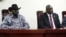 FILE - South Sudanese President Salva Kiir, left, and opposition leader Riek Machar attend the signing ceremony after the two leaders sealed an agreement on a key military provision of their faltering peace deal at the state house in Juba, April 3, 2022.