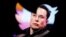 FILE - Elon Musk's photo is seen through a Twitter logo in this illustration created Oct. 28, 2022. As of Dec. 21, 2022, Musk was seeking a new leader to run the social media network.