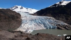 FILE - Chunks of ice float on Mendenhall Lake in front of the Mendenhall Glacier on May 30, 2022, in Juneau, Alaska. 