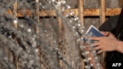 Asylum seekers from Ukraine wait for US border authorities to allow them in on the Mexican side of the San Ysidro Crossing port in Tijuana, Baja California state, Mexico, on March 24, 2022.