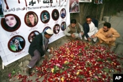 FILE - In this May 3, 2018 file photo, Afghan residents light candles to pay tribute to Afghan journalists killed three days earlier in a suicide attack in Kabul, Afghanistan.