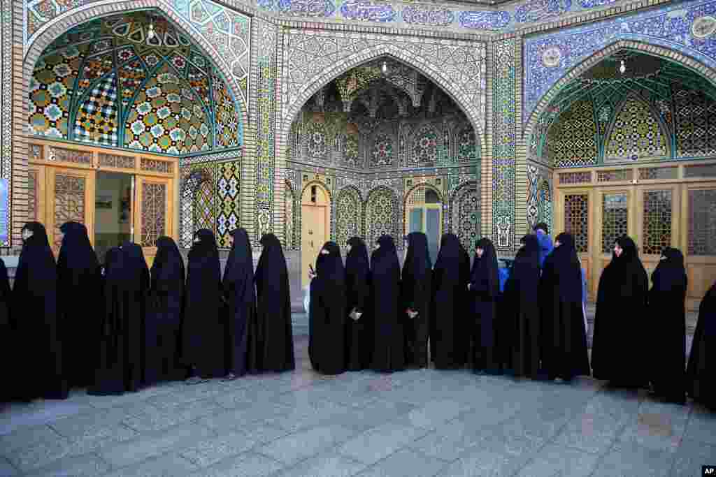 Iranian women stand in line at a polling station during the parliamentary and Experts Assembly elections in Qom, 125 kilometers (78 miles) south of the capital Tehran, Iran, Feb. 26, 2016. 