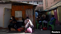 Inmates sit together at a prison that offers access to a small library as part of a program that aims to spread literacy and offer the chance to get out of jail earlier, in La Paz, Bolivia April 29, 2022. (REUTERS/Claudia Morales)