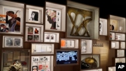 Artifacts are displayed on the archive wall at the Bob Dylan Center, May 5, 2022, in Tulsa, Okla.
