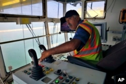 A port employee trains on a container crane in the port of the northern city of Tripoli, Lebanon, Aug. 9, 2017.