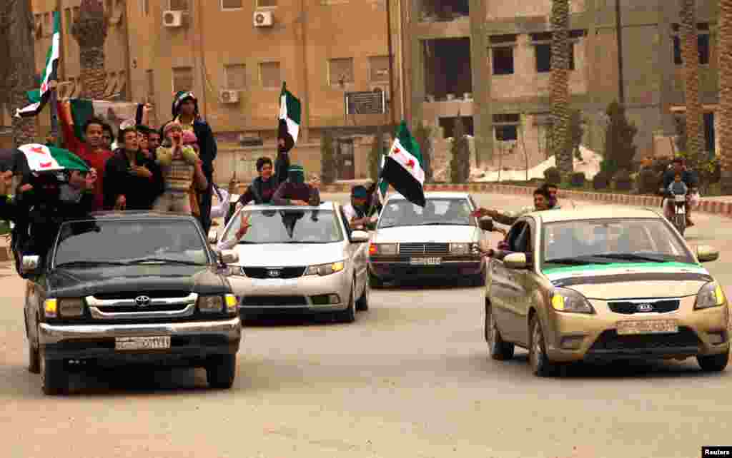 Demonstrators shout during a protest in Raqqa, Syria, marking two years since the start of the uprising in the country, March 15, 2013.