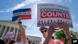 Immigration activists rally outside the Supreme Court as the justices hear arguments over the Trump administration's plan to ask about citizenship on the 2020 census, in Washington, April 23, 2019.
