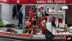 Italian firefighters are docked at the harbor of Porticello, southern Italy, Aug. 20, 2024, as rescue teams returned to the site of a storm-sunken superyacht to search for six people, including British tech magnate Mike Lynch.